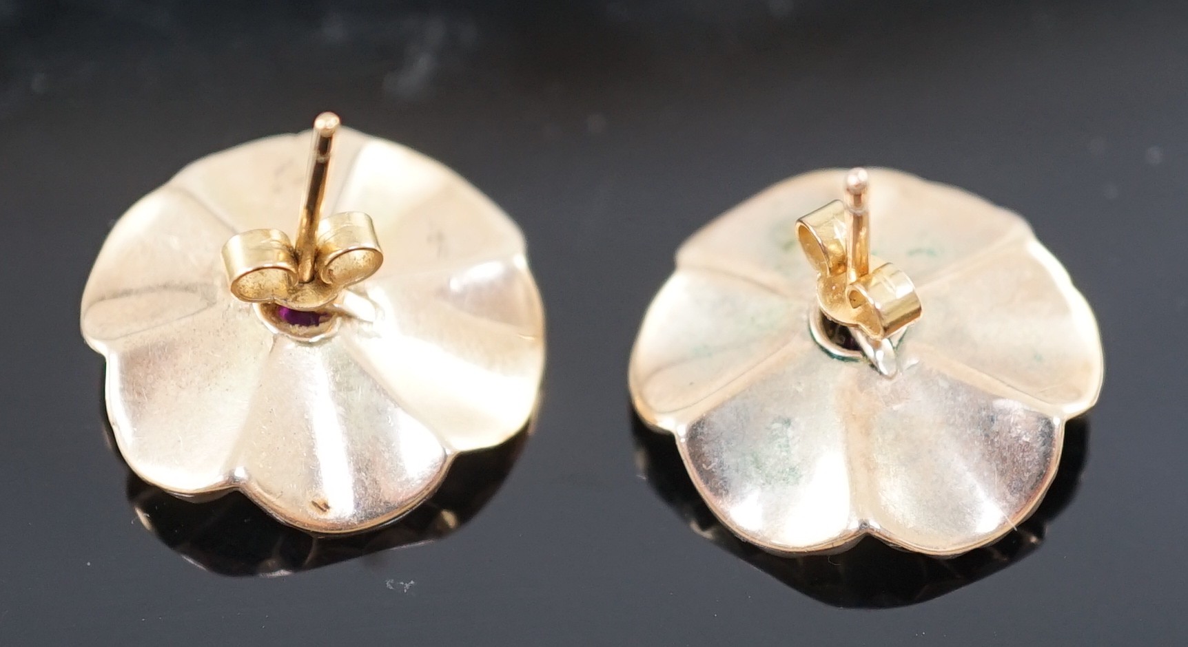 A pair of 1950's gold, ruby and diamond cluster set flower head earrings